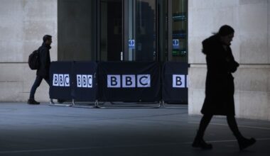 People walking by the entrance to BBC’s headquarters