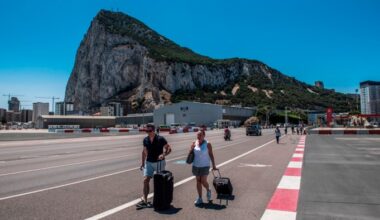 Two tourists cross the border to leave Gibraltar and enter Spain
