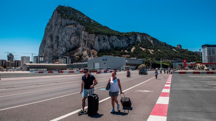 Two tourists cross the border to leave Gibraltar and enter Spain