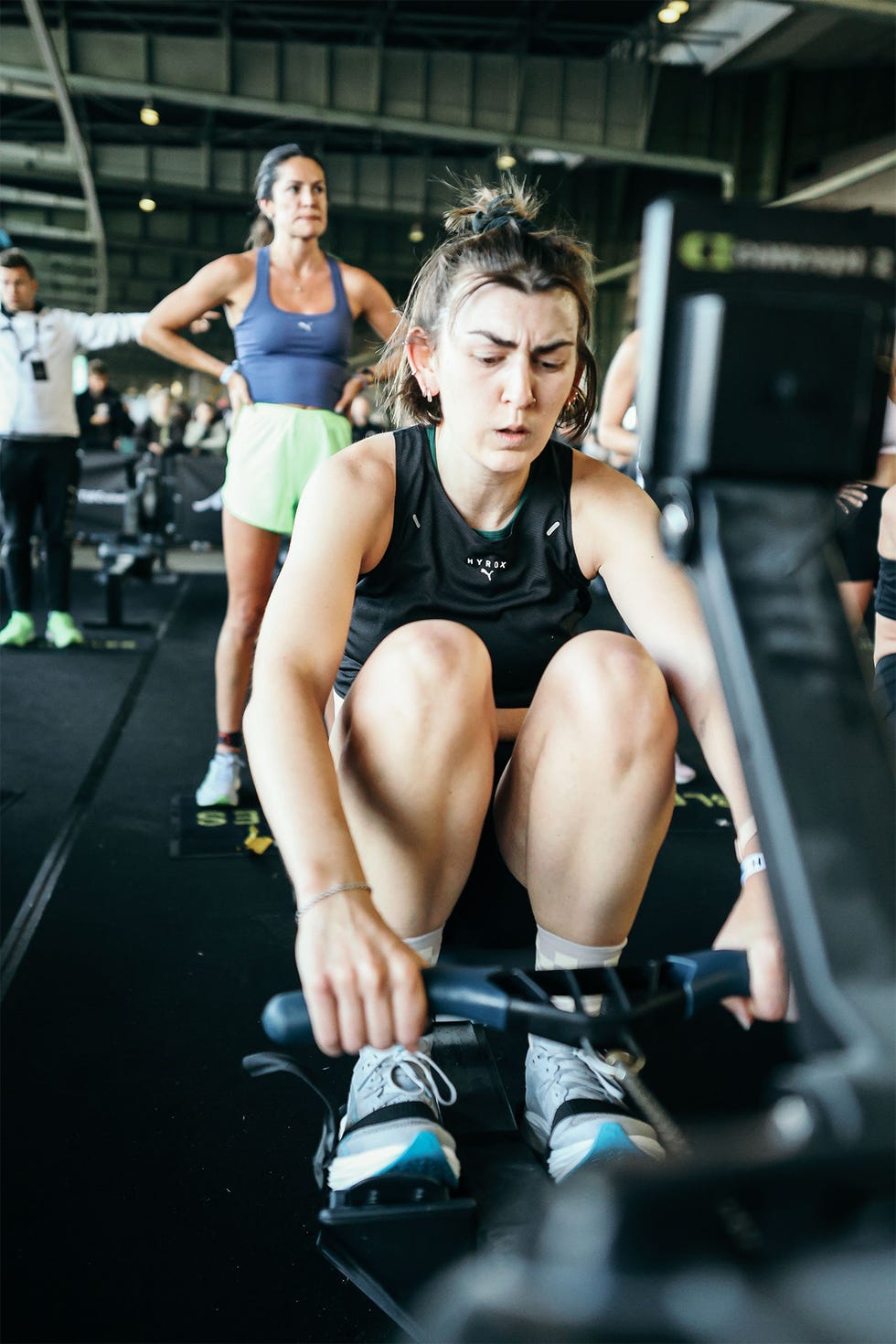 a woman on a rowing machine during a fitness competition