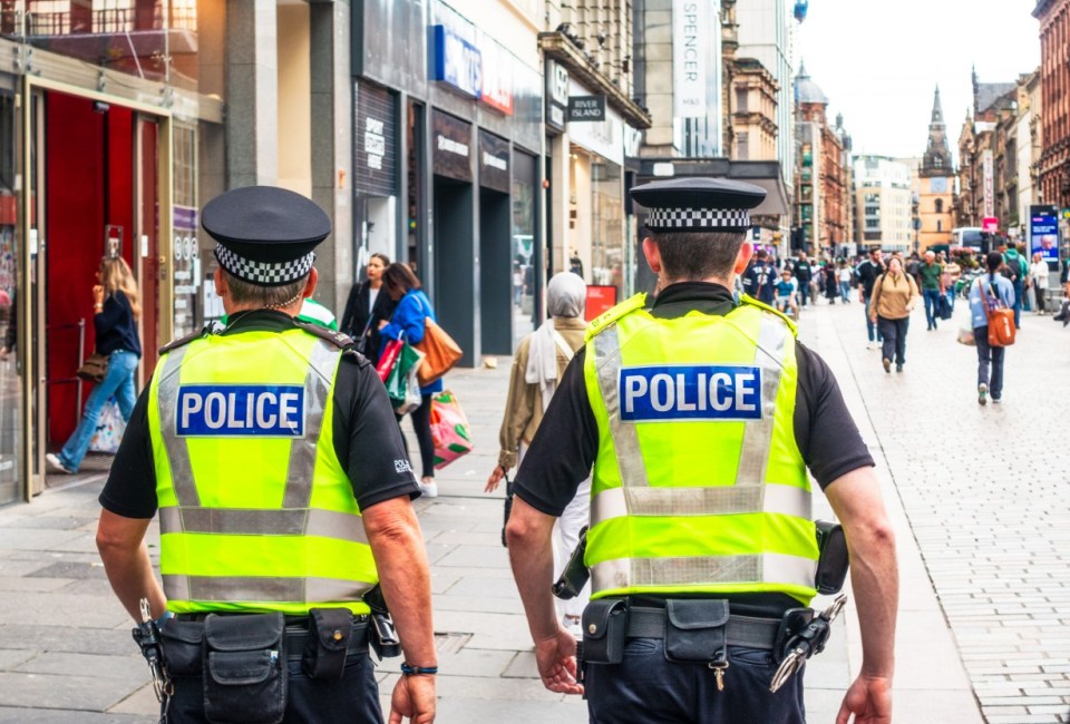 Two police officers walking down a city street.