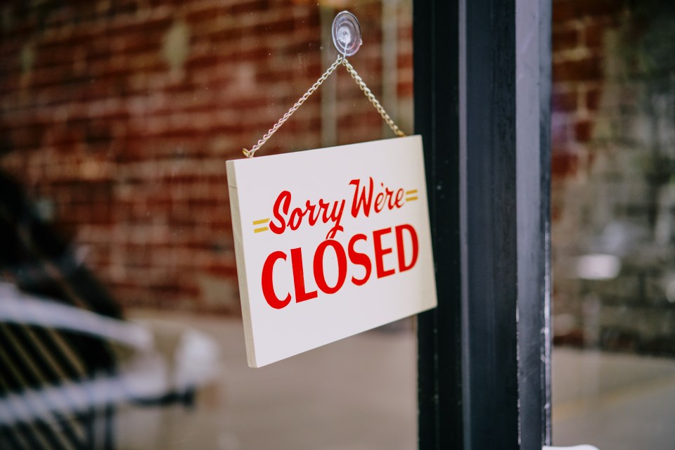 Sorry we're closed sign on store window door
