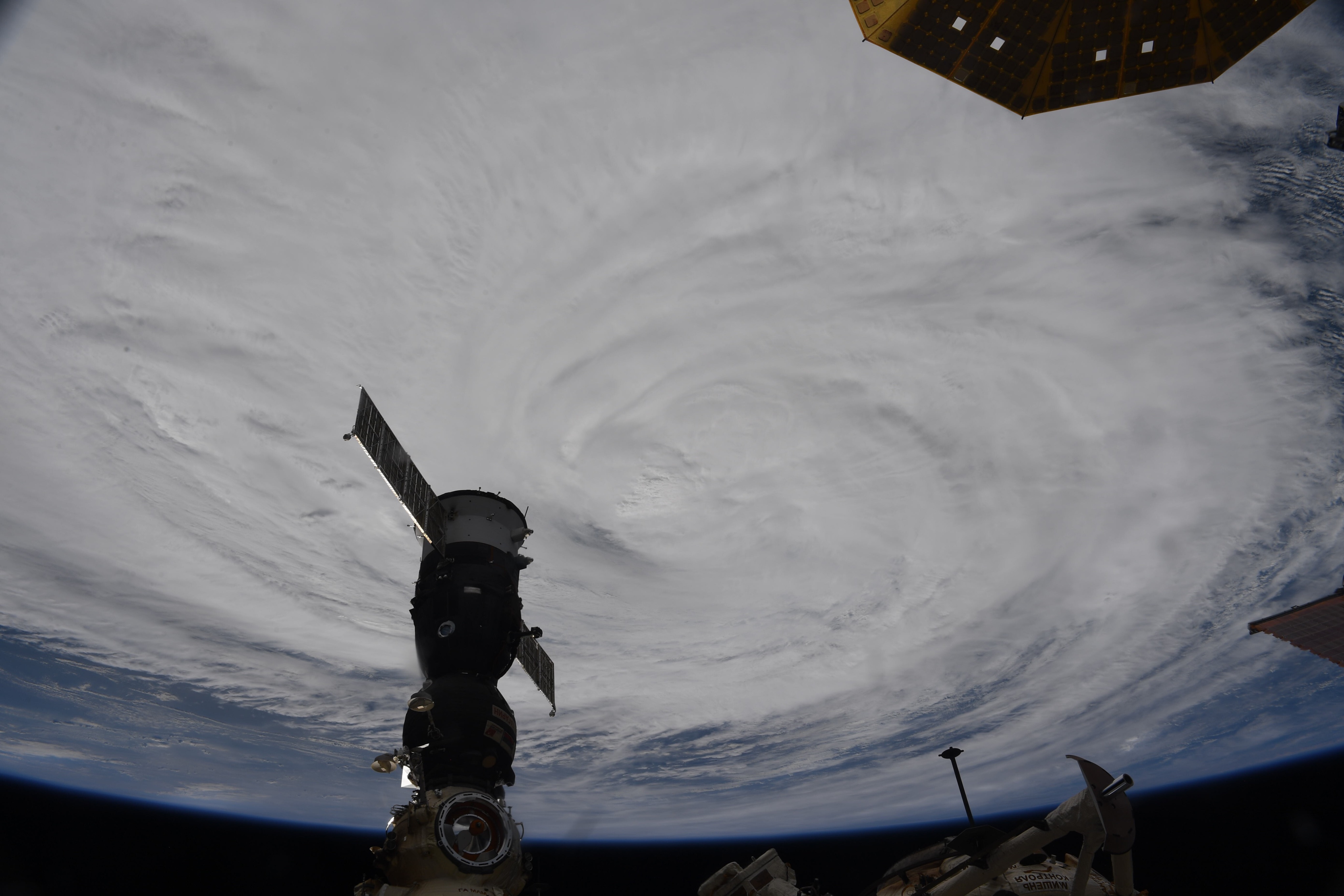 A disk of white clouds on a dark background