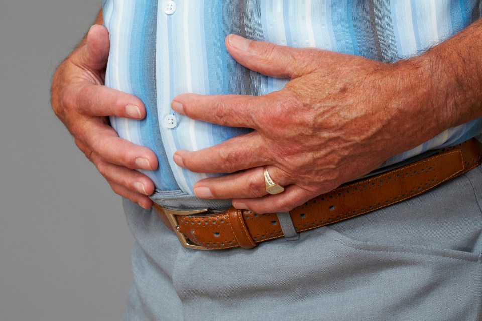 Senior man holding his stomach.