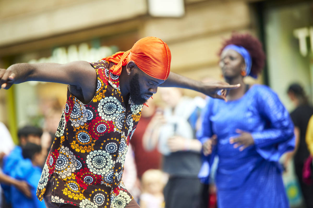 man dancing in the street in manchester