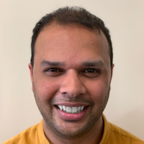 Headshot of a smiling man.