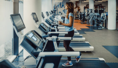 Woman walking on treadmill in empty gym