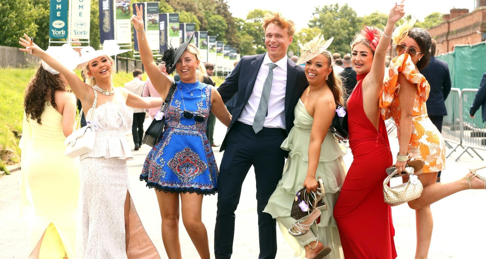 Glamorous racegoers make the most of the hot weather in colourful mini dresses and eye-catching hats at York races