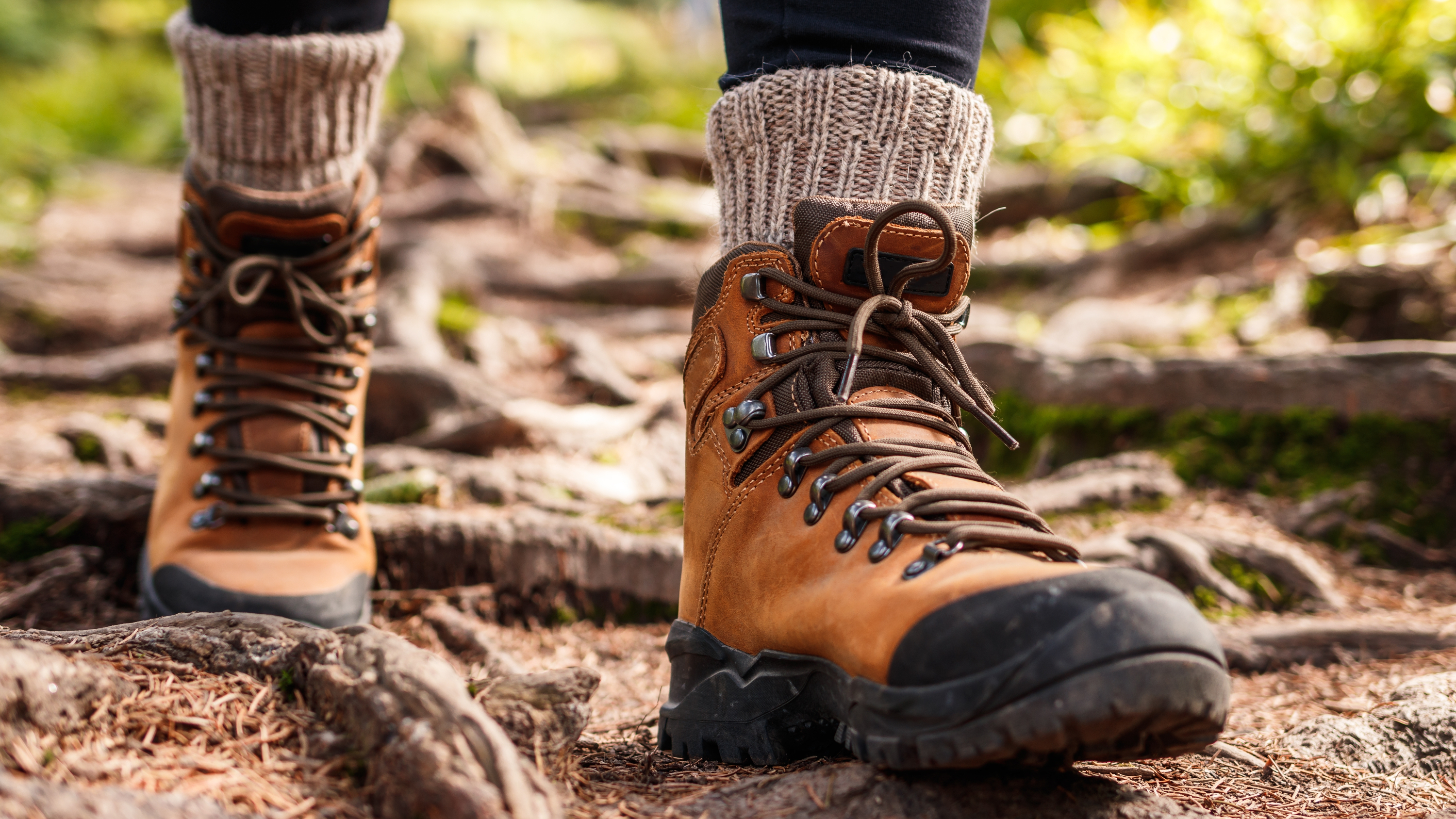 a person walking in hiking boots through woodlands