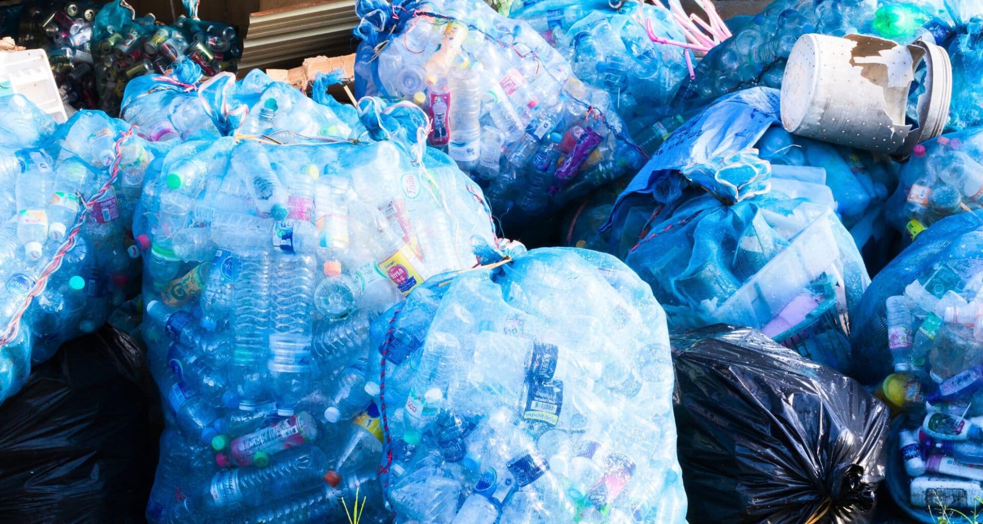Plastic Bottles Waste In Big Plastic Bags At Recycle Center