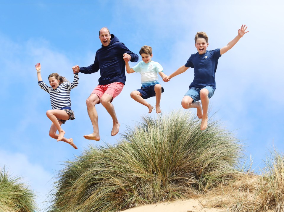 a group of people are jumping in the air while holding hands