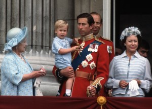 Prince Charles, Prince of Wales holds young Prince William on the balcony of Buckingham Palace following the Trooping the Colour ceremony on June 16, 1984 in London, England.