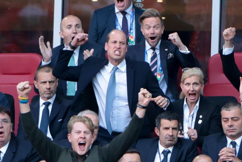 Prince William and others celebrating at a soccer match.