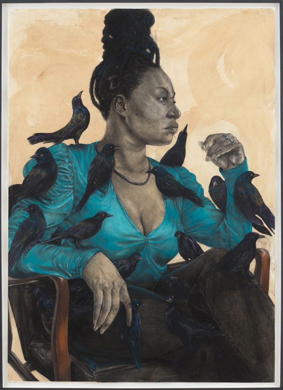 a woman seated in a blue top with grackles perched on her body