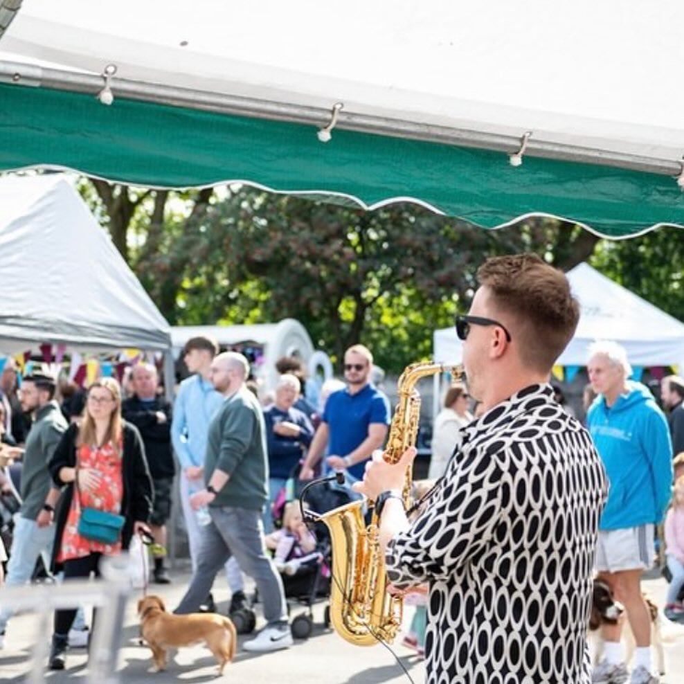 saxophonist by stalls at urmston food and drink festival