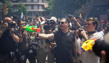People shoot in the direction of tourists with water guns during a protest against overtourism in Barcelona, Spain. Pic: AP