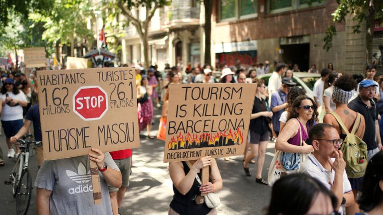 People march during a protest against overtourism in Barcelona, Spain. Pic: AP