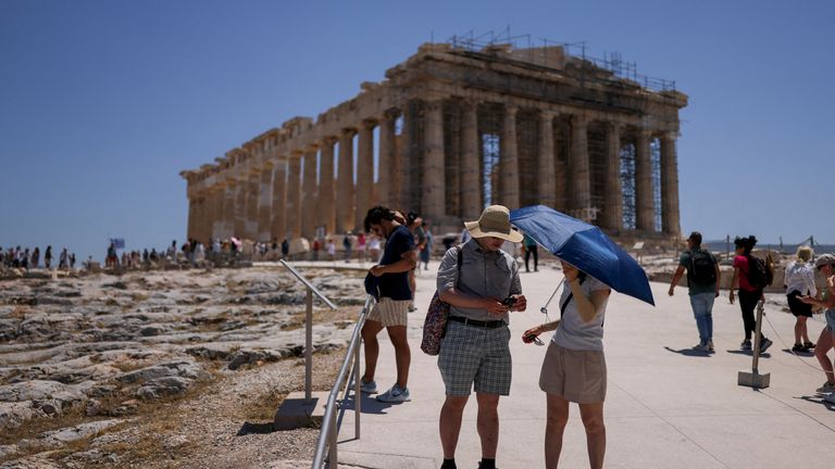 Tourists battle scorching temperatures at the Parthenon in Greece on Friday. Pic: Reuters