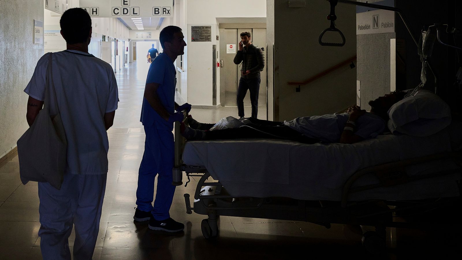 A medical staffer relocates a patient during a nationwide power outage in Pamplona, northern Spain, Monday, April 28, 2025. (AP Photo/Miguel Oses)