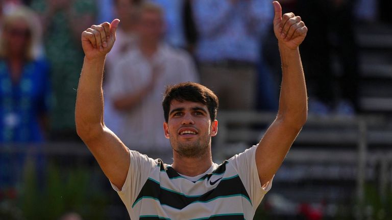 Spain's Carlos Alcaraz reacts after beating Australia's Adam Walton during their men's singles match at the Queen's Club grass court tennis 