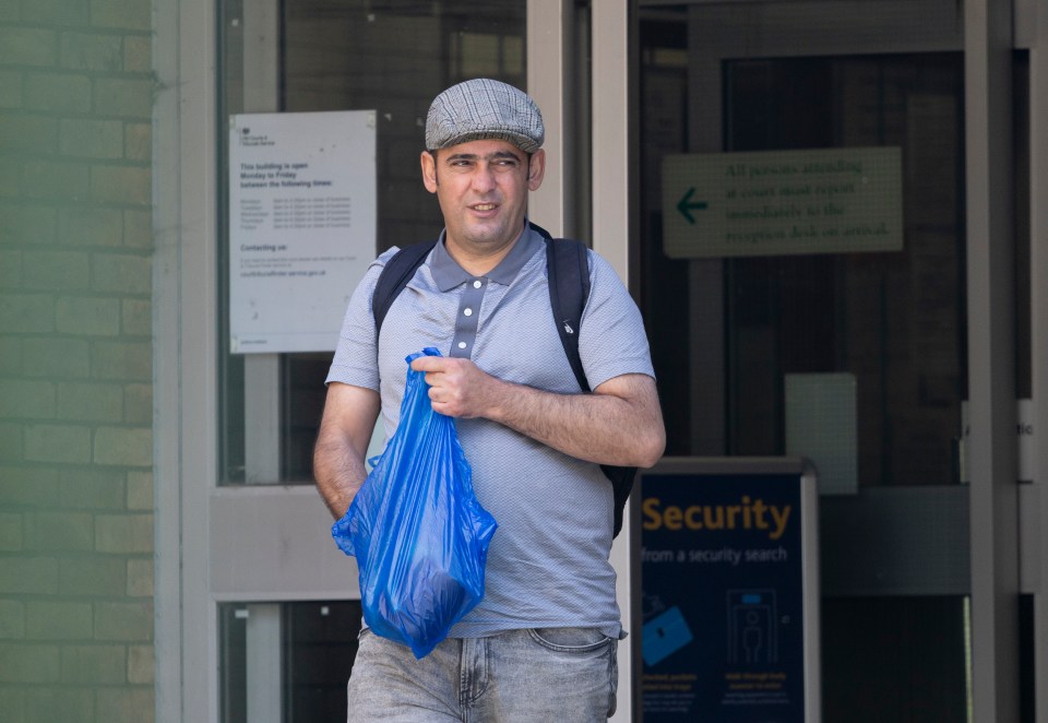 Man leaving courthouse carrying a blue bag.