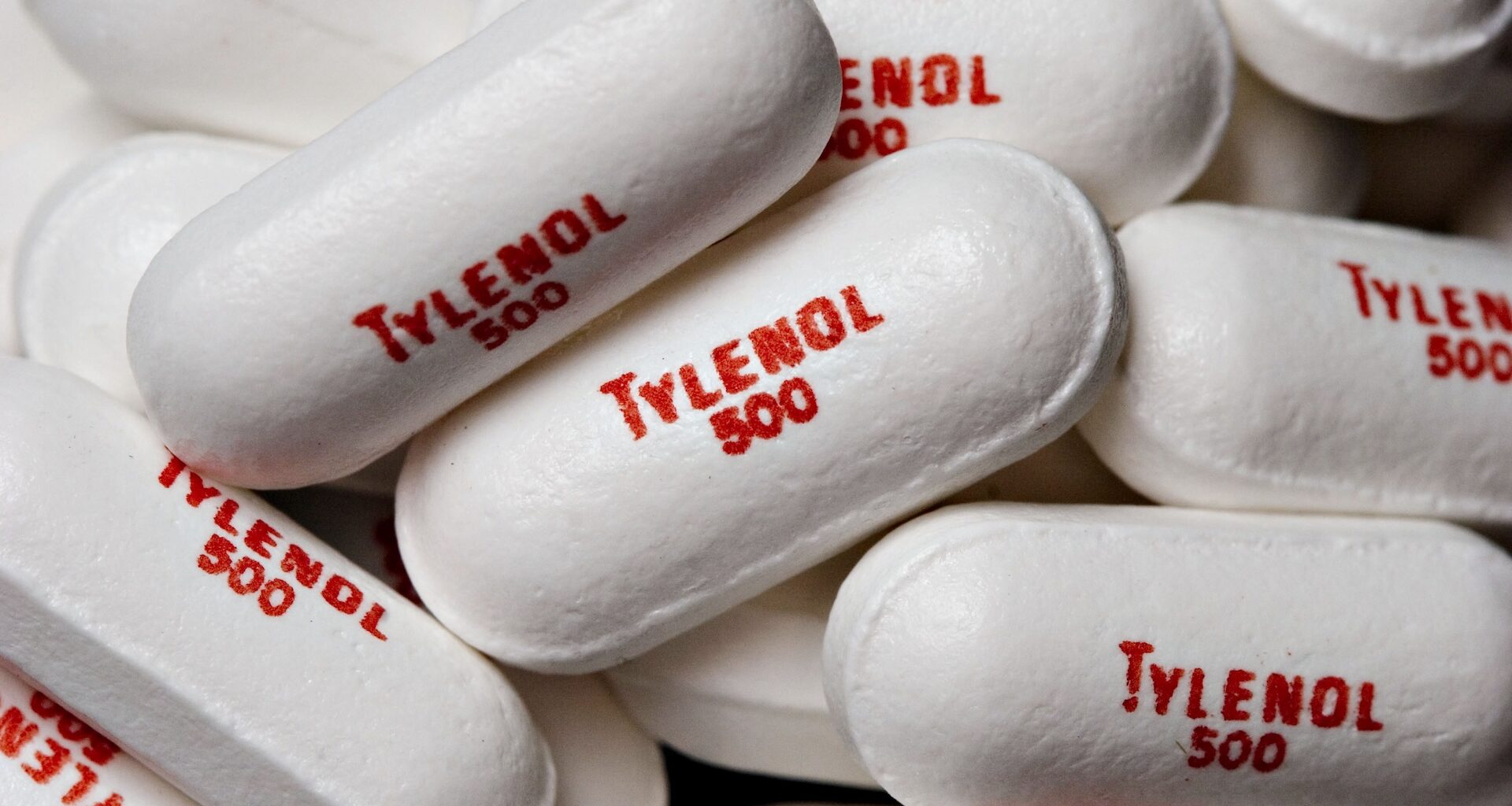 a close-up of white pills printed with the words &quot;Tylenol 500&quot;