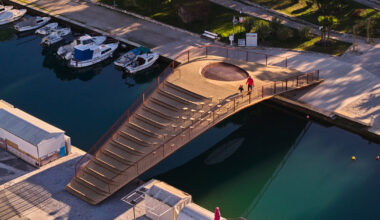 steel bridge with integrated net seating expands over port in croatia