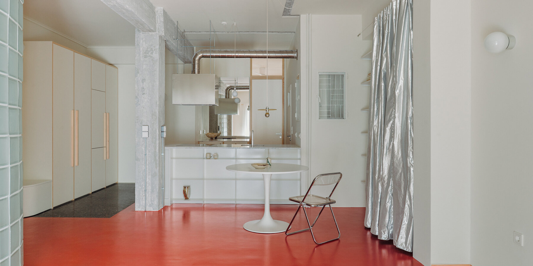 red floor runs over minimal 1970s athens apartment by threshold