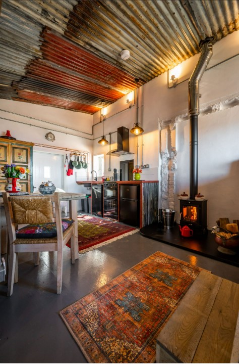 Interior view of a rustic kitchen and living area in a lighthouse.