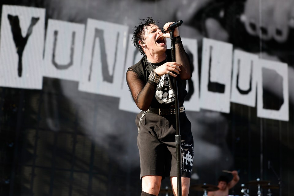 Yungblud performing at an outdoor music festival.