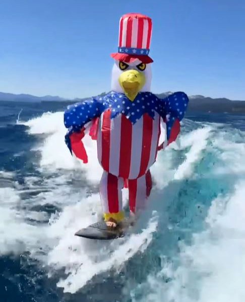 Eagle in Uncle Sam costume wakeboarding.