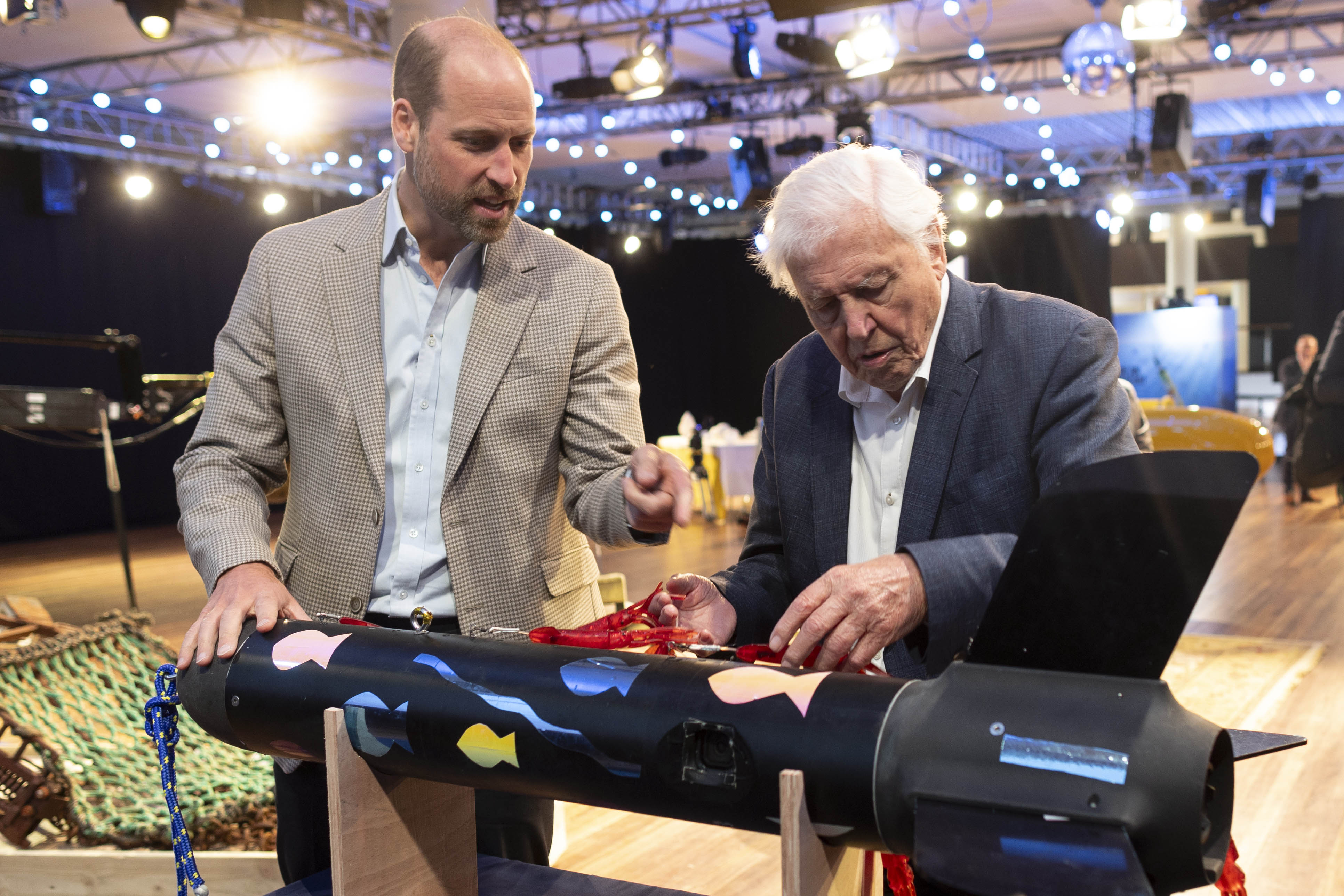 Prince William and Sir David Attenborough examining an ocean exploration device.