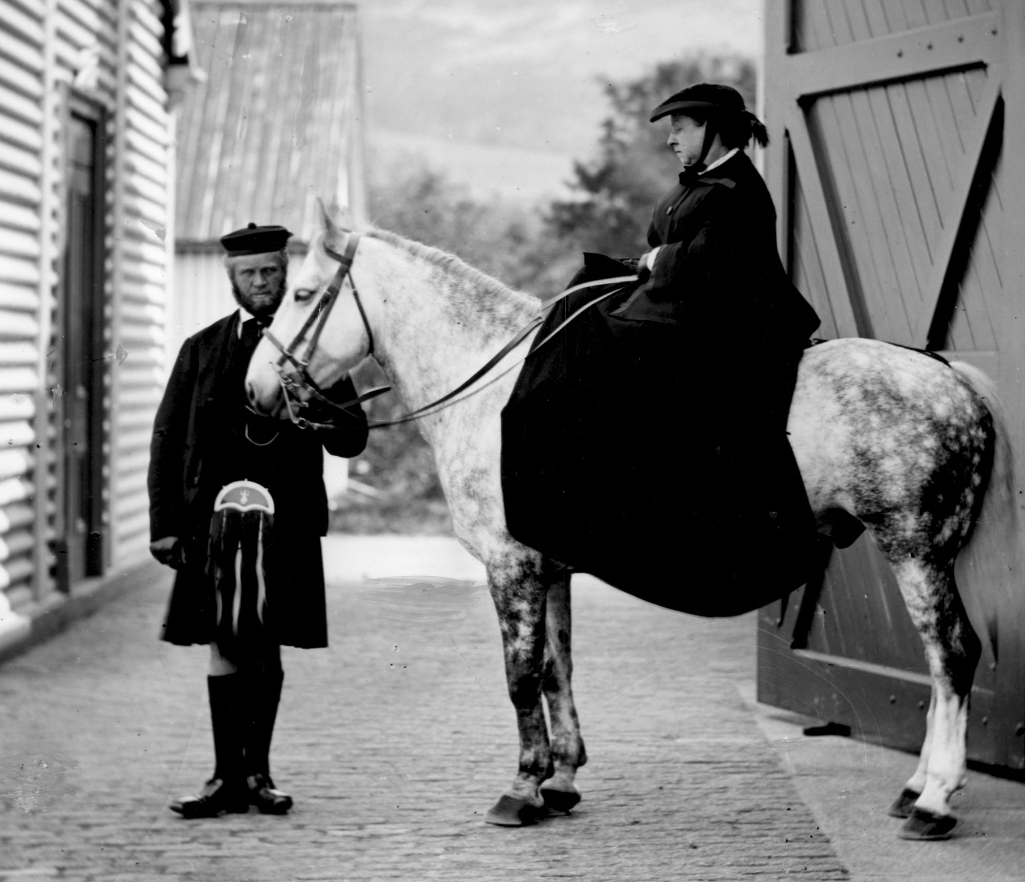 Queen Victoria horseback riding at Balmoral with John Brown.