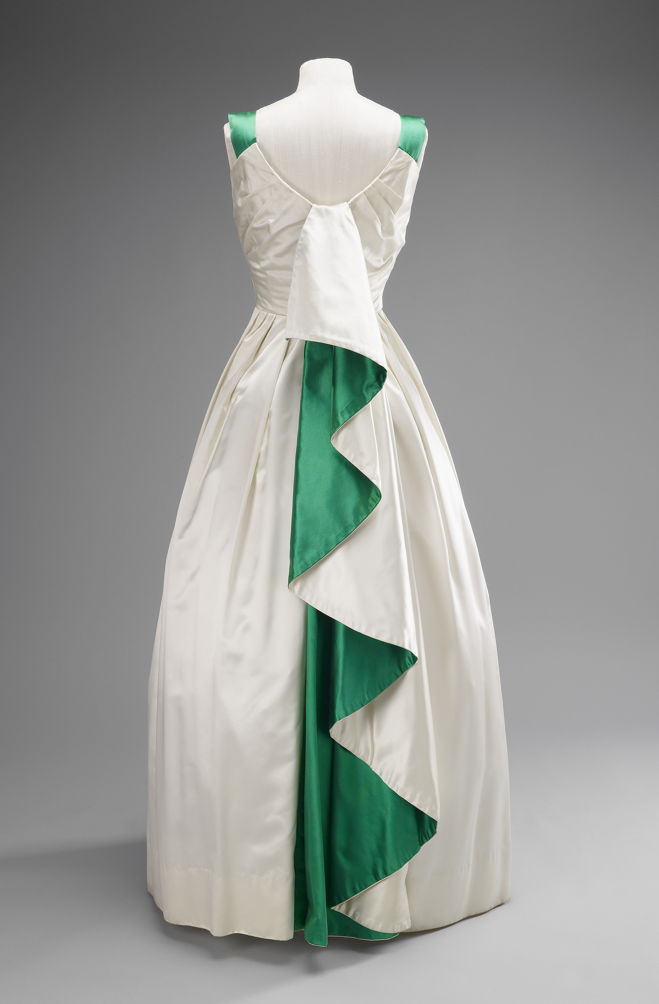 Off-white gown with a cascading green satin train.