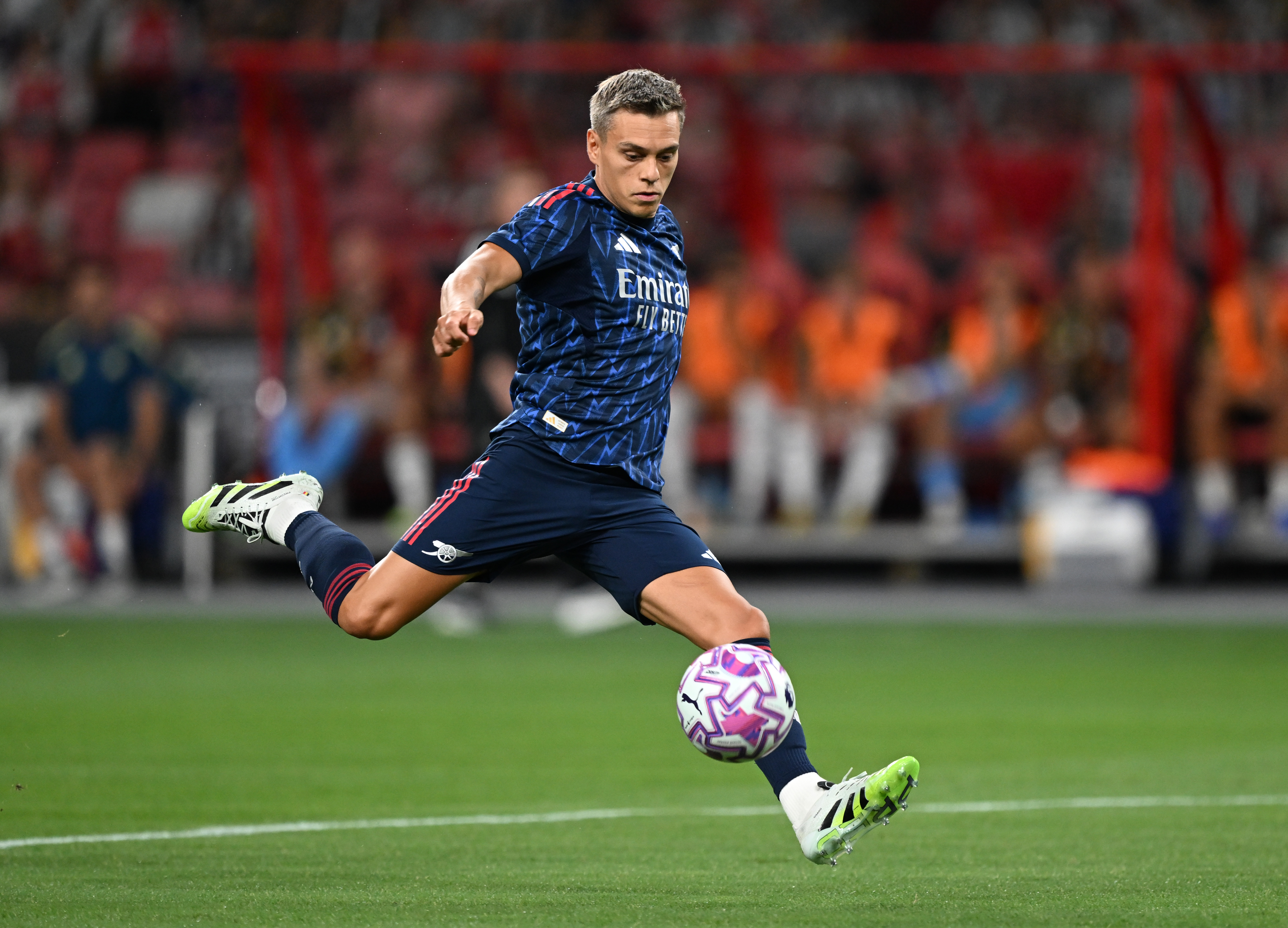 Leandro Trossard of Arsenal kicking a soccer ball.