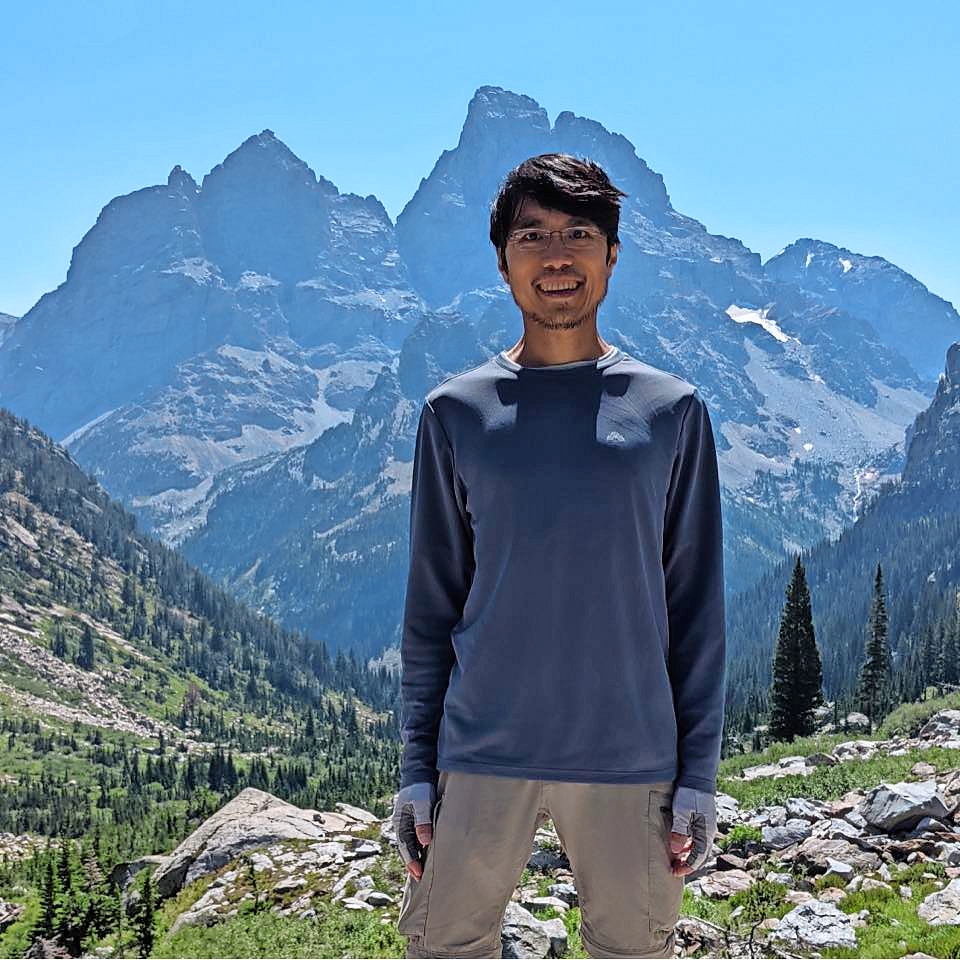 Ruoming Pang in front of mountains.