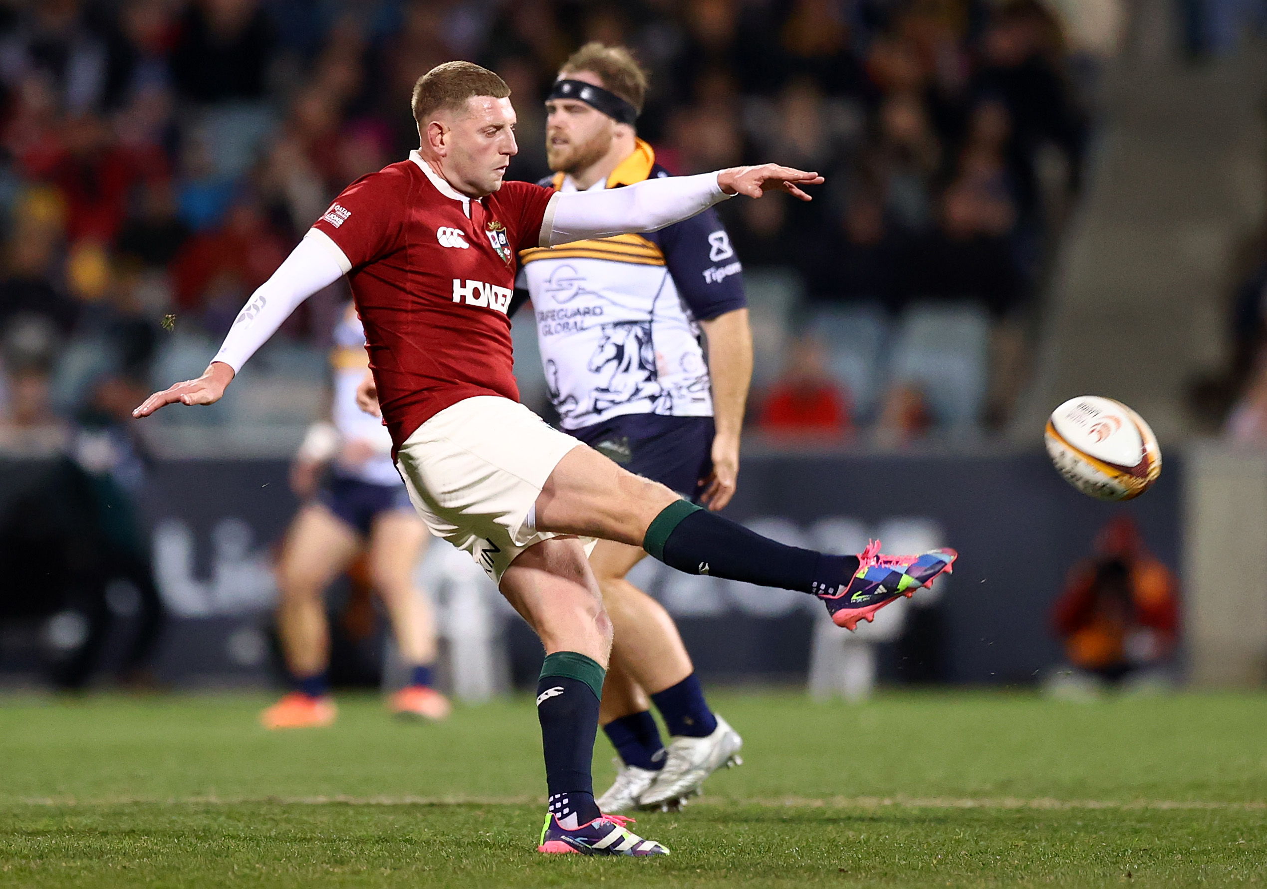 Finn Russell of the British and Irish Lions kicking a rugby ball during a match.