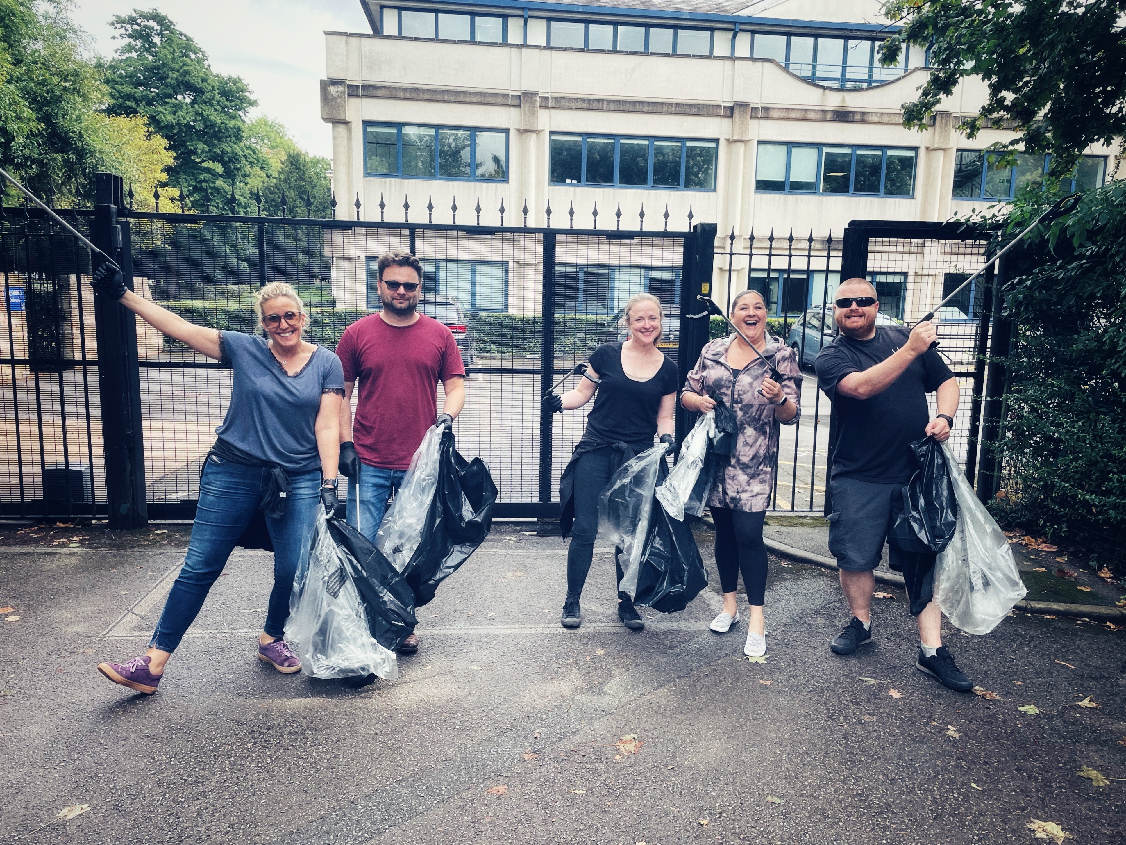 Five people picking up litter.