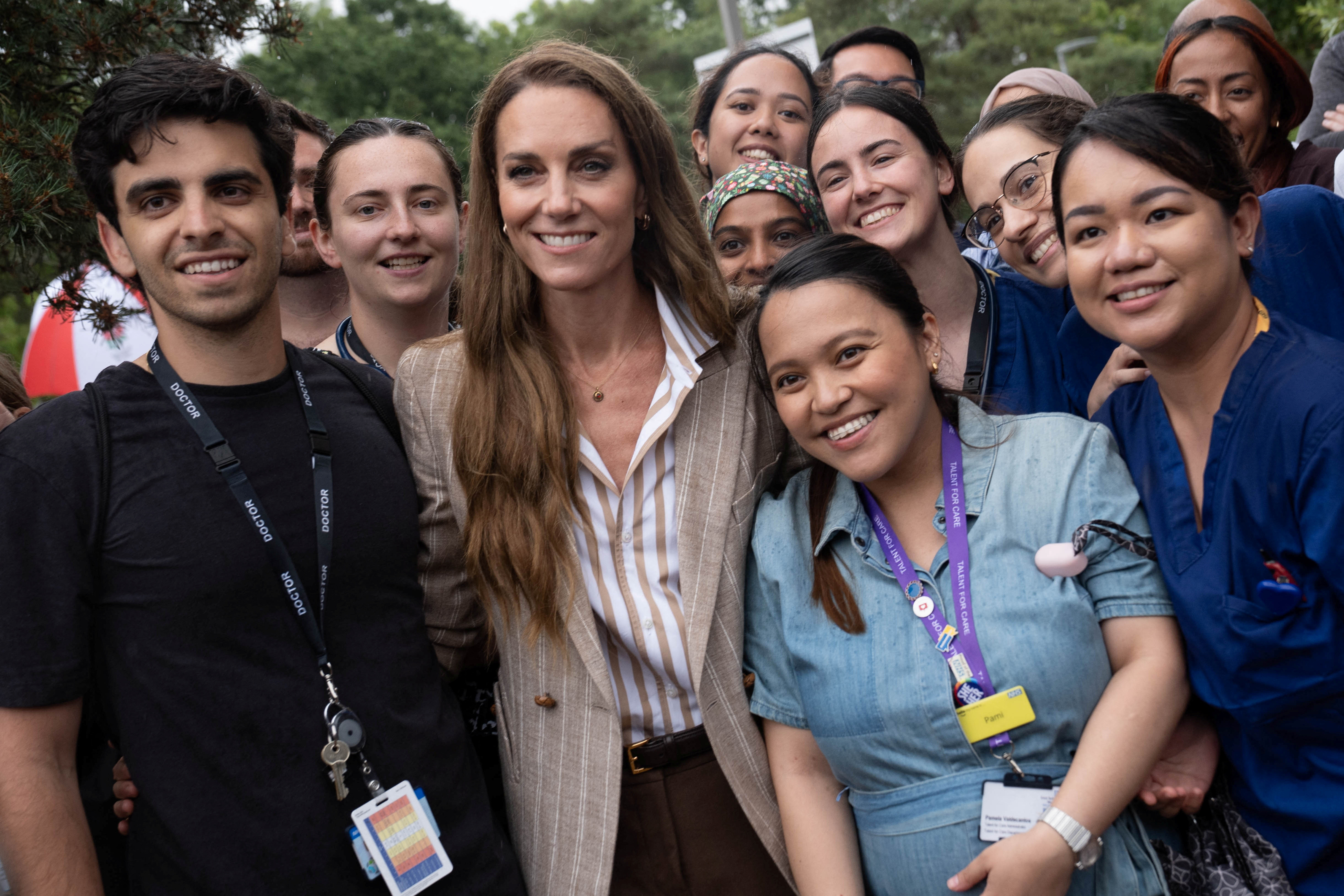 Catherine, Princess of Wales, surrounded by hospital staff.