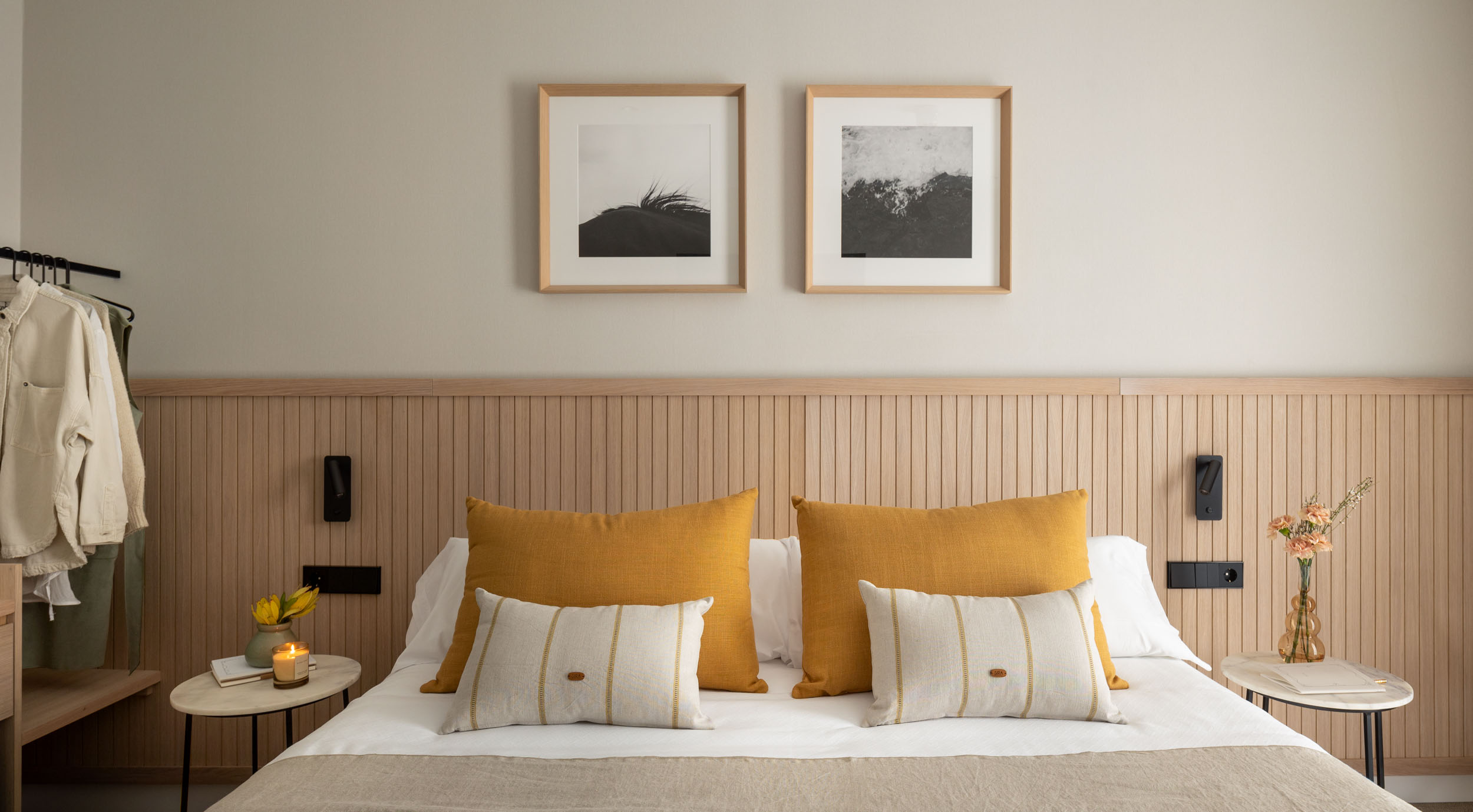 Hotel Nirea room with bed and minimalist decor.