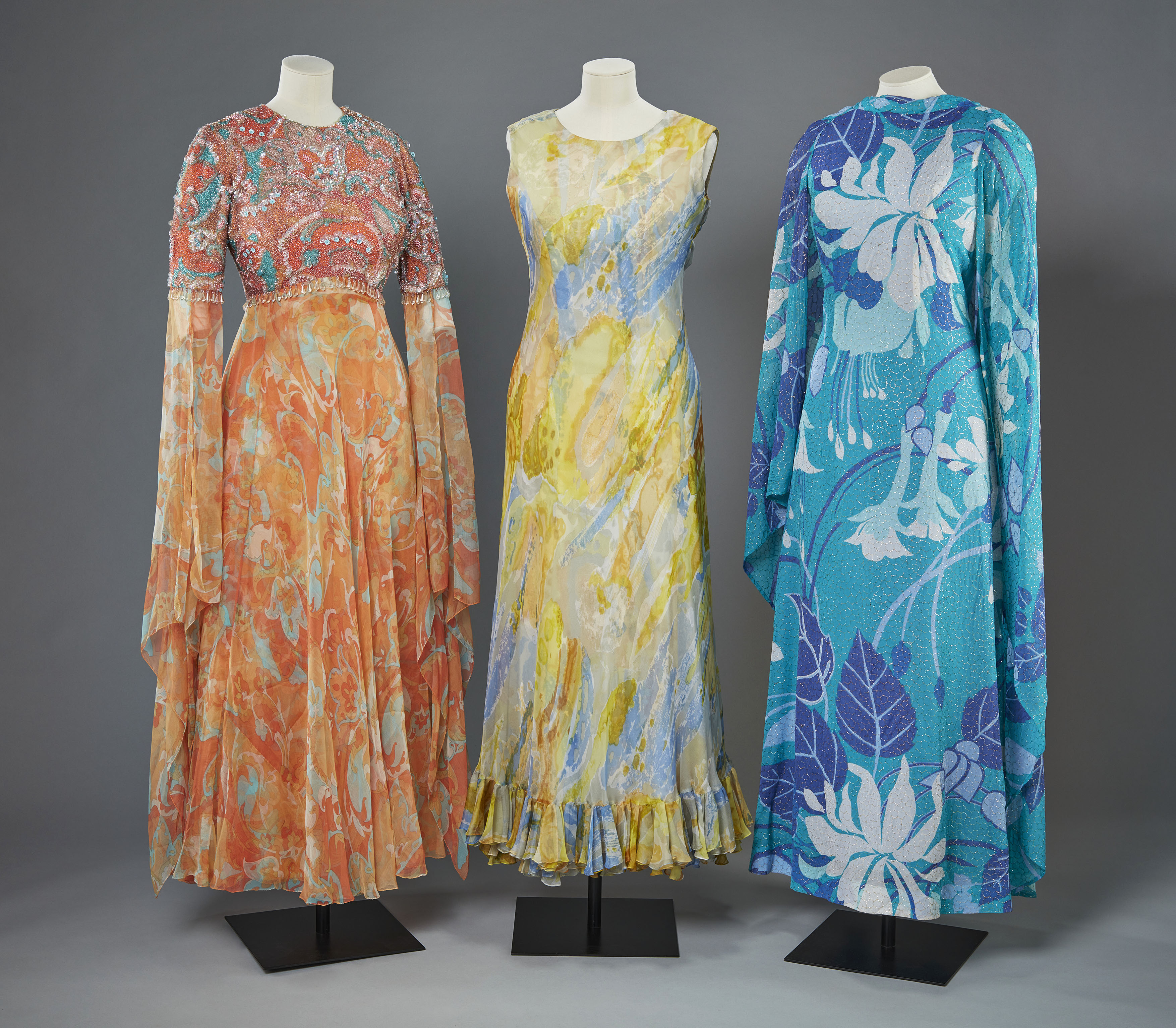 Three evening gowns on display.
