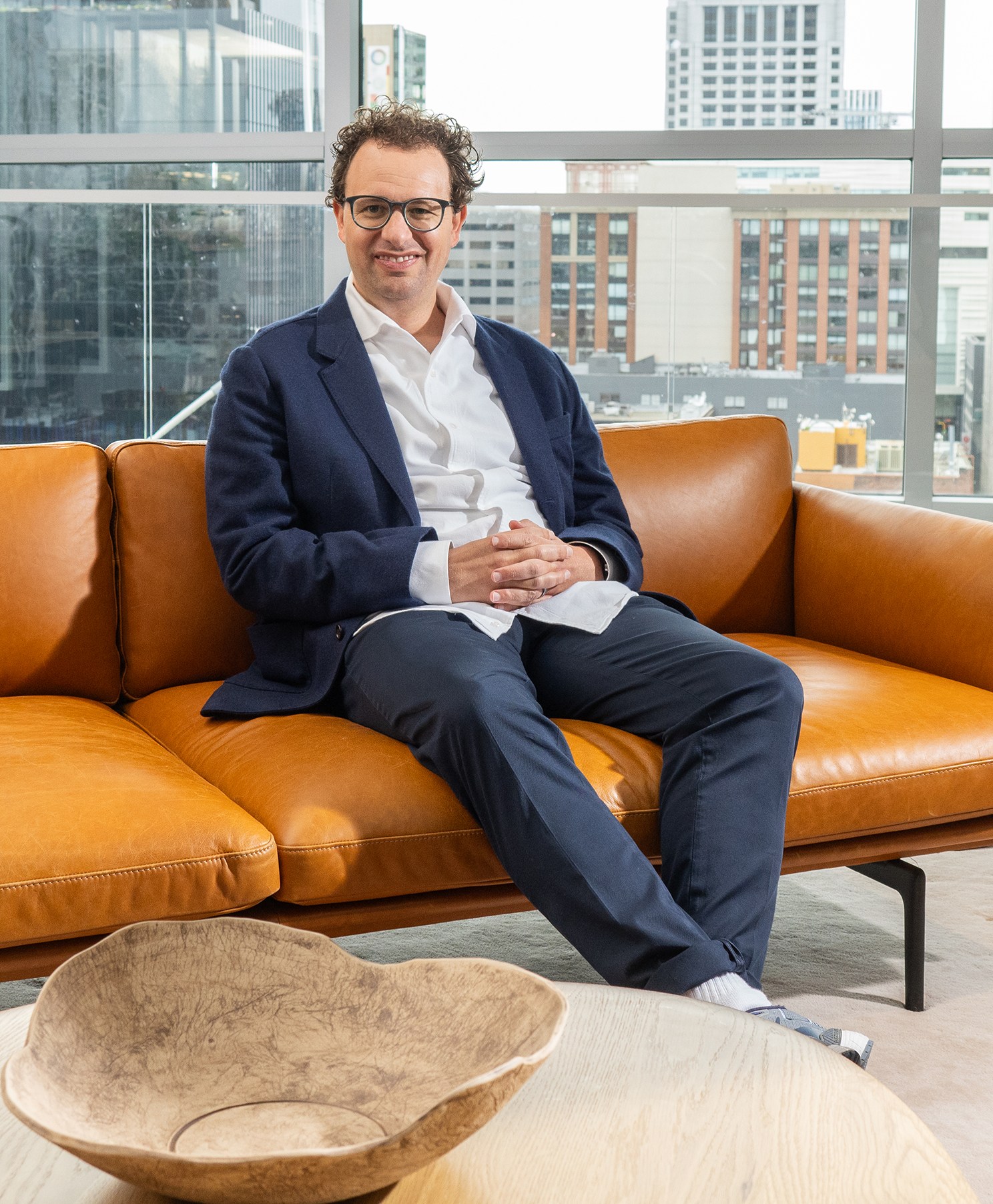 Dario Amodei, CEO of Anthropic AI, sitting on a couch.