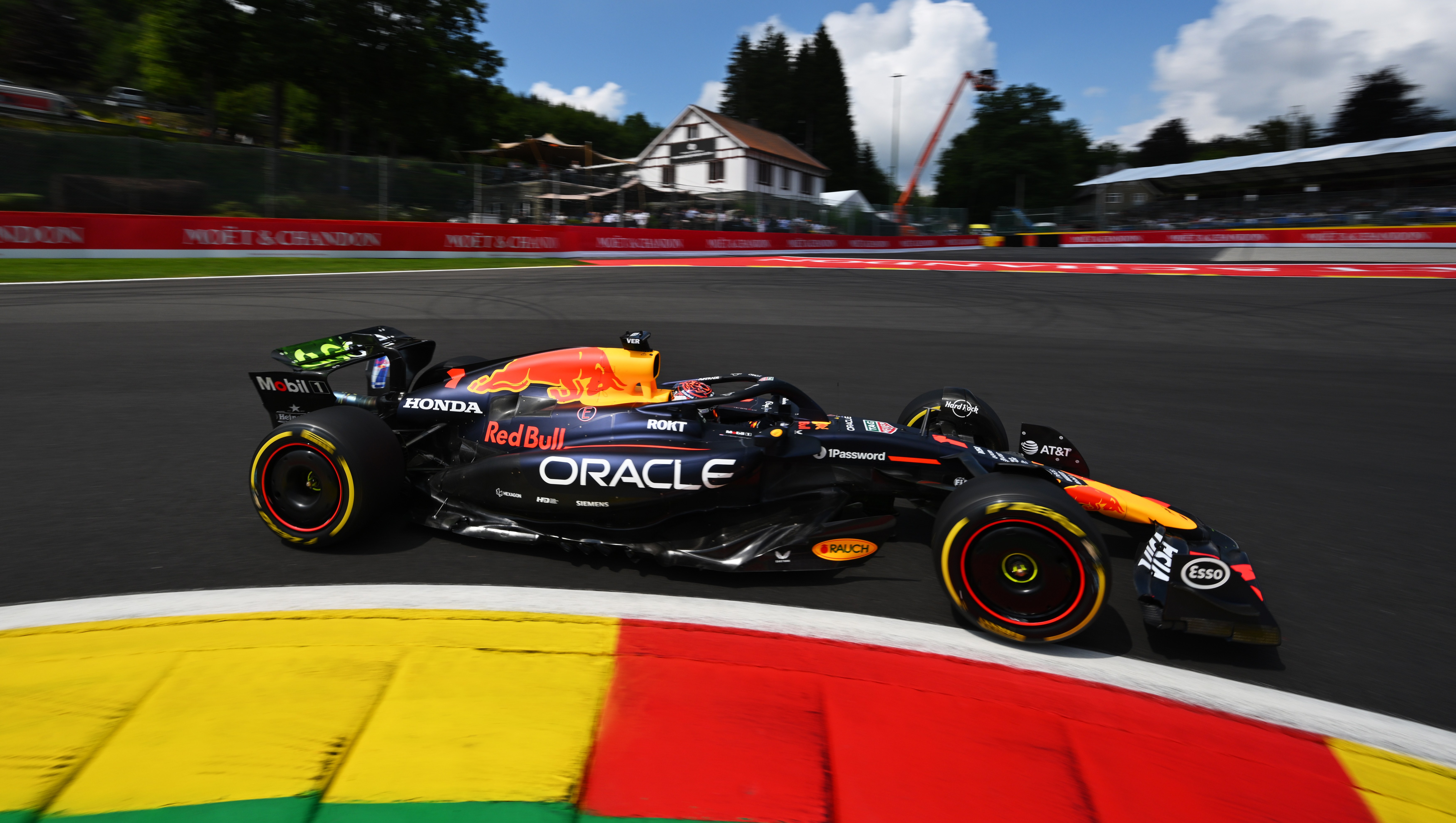 Max Verstappen's Red Bull Racing car speeding around a racetrack.