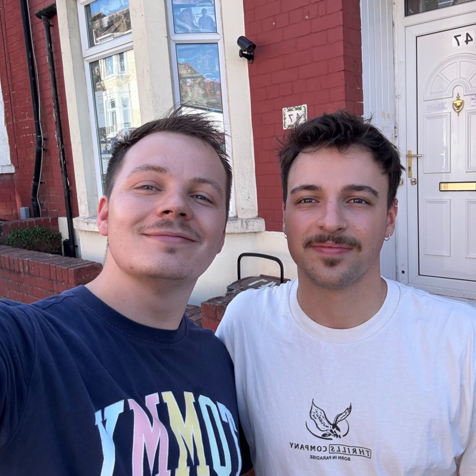 Selfie of two men in front of a house.