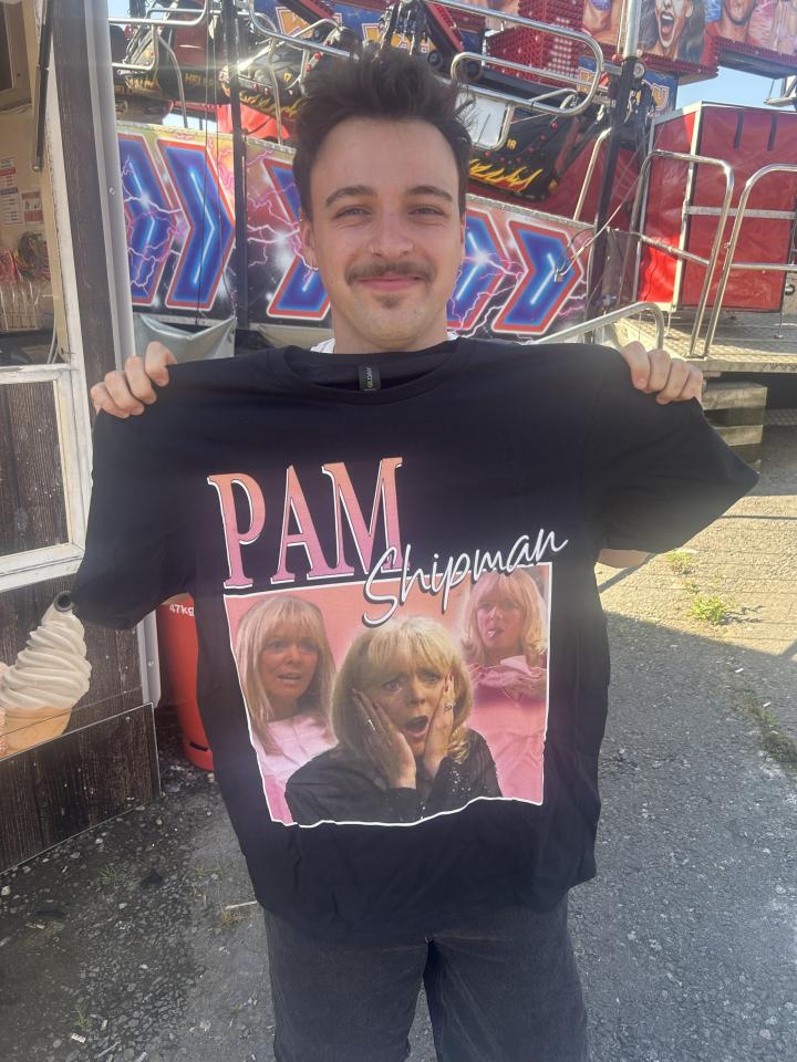 Person holding up a black t-shirt with a Pam Shipman design from the TV show Gavin & Stacey.