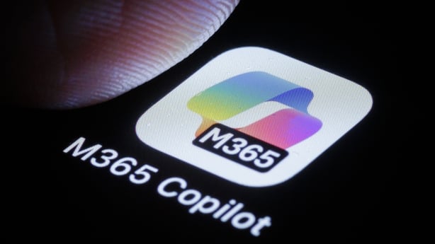 The Microsoft 365 Copilot app is displayed on a smartphone