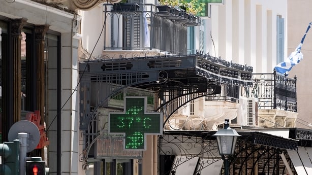 A pharmacy sign displays '37C' during a heatwave in Athens, Greece, on 22 July 22