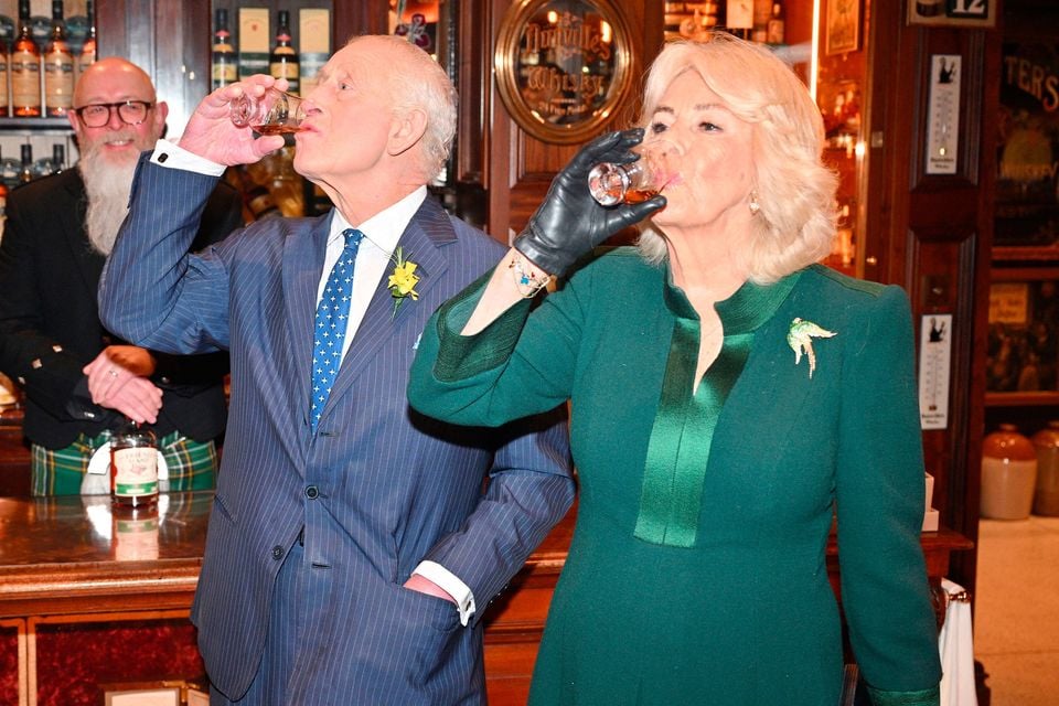 The King and Queen taste whiskey at The Friend at Hand during a visit to Commercial Court, Belfast