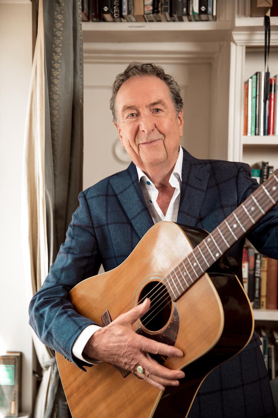 Eric Idle with a guitar