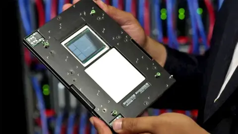 BBC Faisal Islam holds one of the computer's processors 